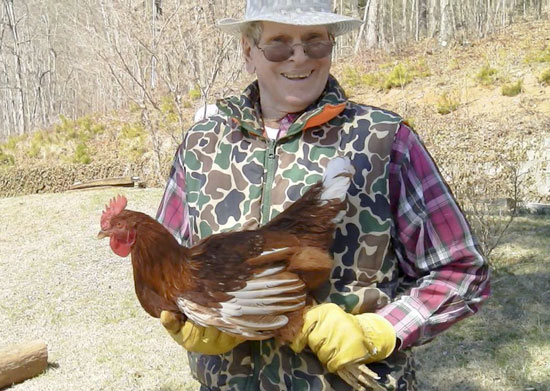 Bill gently holding the very docile rooster prior to getting the axe.