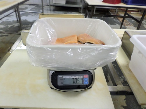 Scale at Sunburst measures the fillets ready for purchase. Sunburst processes about 8,000 pounds of fish a week.