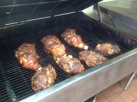 Pork shoulders cook slowly in Lexington-style restaurants, such as in this smoker at Hill’s of Winston-Salem.