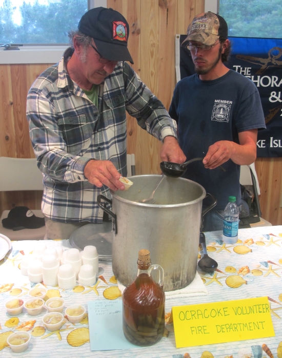 Ocracoke Volunteer Fire Department: Van O’Neal (left) made the chowder, and Brandon Jones (right) helped with the clamming.  O’Neal used his grandmother Elsie Garrish’s recipe, though he has also learned from watching others make chowders, likes many variations of it, and is known in the area for his fish stew, too.  Ingredients: clams fresh, salt pork, onions, taters, salt, pepper.  Photo: Leanne E. Smith, 4-4-2015. 