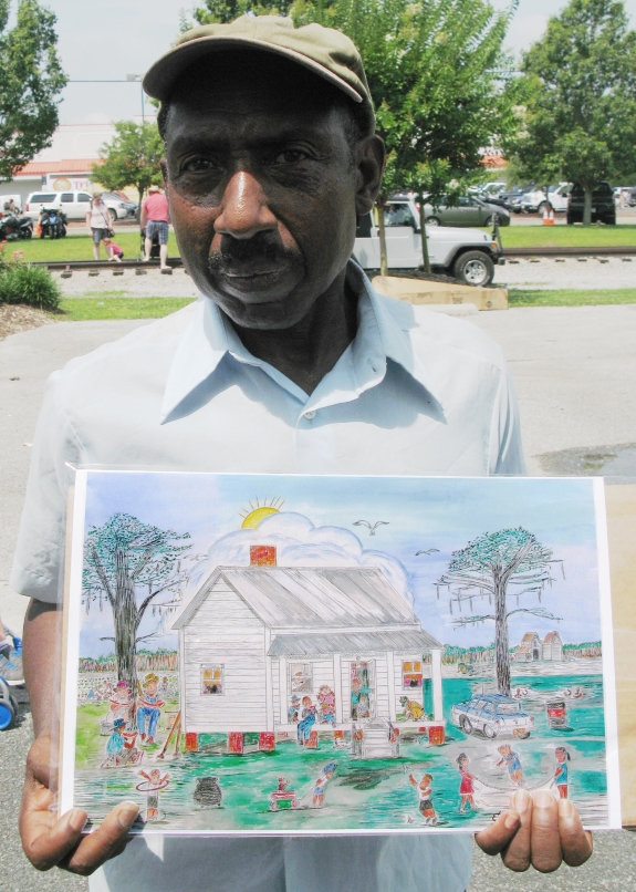 Eddie Hayes with one of his favorite pieces of artwork.  Saturday, June 20, 2015.  Photo: LeanneE. Smith.
