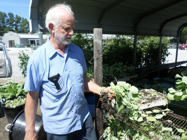 Robert Jones, 89, never rests as he unloads another tray of bedding plants.