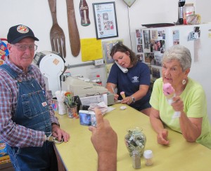 During an ice cream break, Margo writes down a phoned-in order, and Margie talks with customers and poses for pictures.  Monday, September 7, 2015.  (Leanne E. Smith)