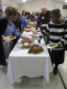 Members of three congregations prepare to enjoy food made by Bethesda Presbyterian members. (Ray Linville)