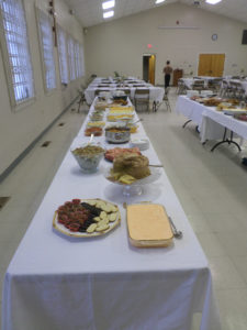 As the music program was ending, two tables were prepared to serve food buffet-style. (Ray Linville)