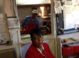  Linda McRae (front) takes orders as her father prepares food in the kitchen behind the window. (Ray Linville)