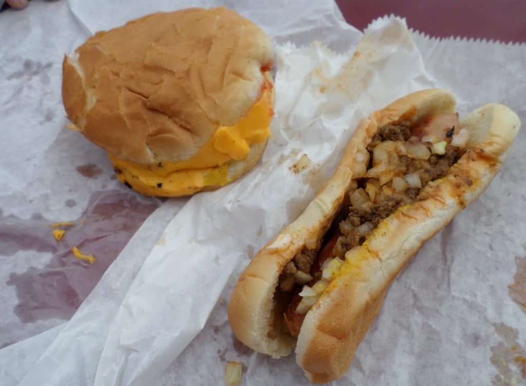 A complete lunch for many customers is a cheeseburger and a hot dog.
