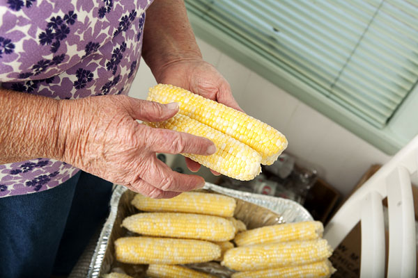 Alice's trained eye can discern which cob will have more "cream" to reap from its kernels.