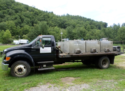Truck and containers show how small trout are brought to Sunburst from its supplying farms.