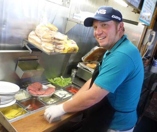 Scott Drye cuts a slice from a loaf of livermush as he prepares to make my sandwich.