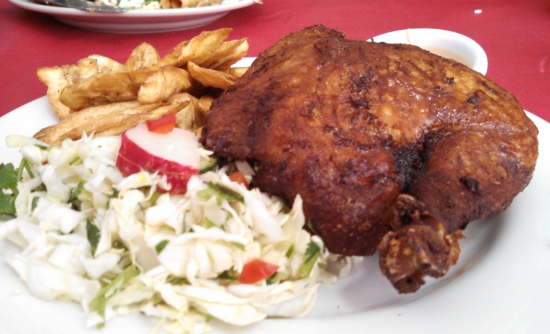 Pollo con Tajadas: fried chicken served with green plantains, cabbage salad in their unique pink sauce.