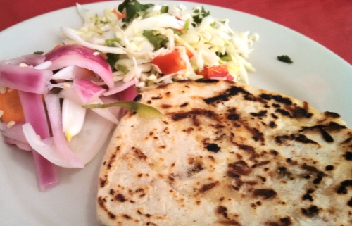 Pupusas: tortilla pies stuffed with either quesillo (little cheese), chicharron (fried pork/rinds), refried beans or a combination. Served with cabbage salad and pickled onions.
