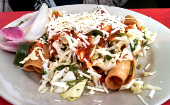Tacos Doraditos: corn tortilla stuffed with shredded chicken, fried until crispy. Served with salad, sauce and shredded cheese.