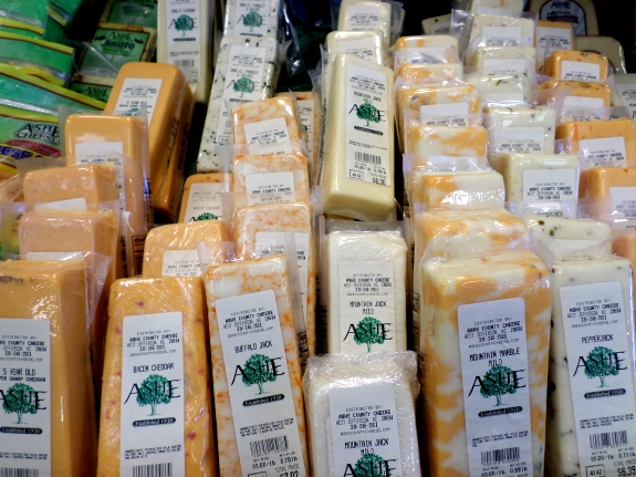 Stacks of Ashe County cheese are displayed for sale at WNC Farmers Market in Asheville.