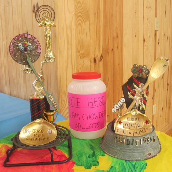 Trophies for the non-traditional chowder (left) and traditional Ocracoke chowder (right) were commissioned from village-based writer and visual artist Susan Dodd, who created mixed media and found-object sculptures dubbed the “Clammy.”  Photo: Leanne E. Smith.  