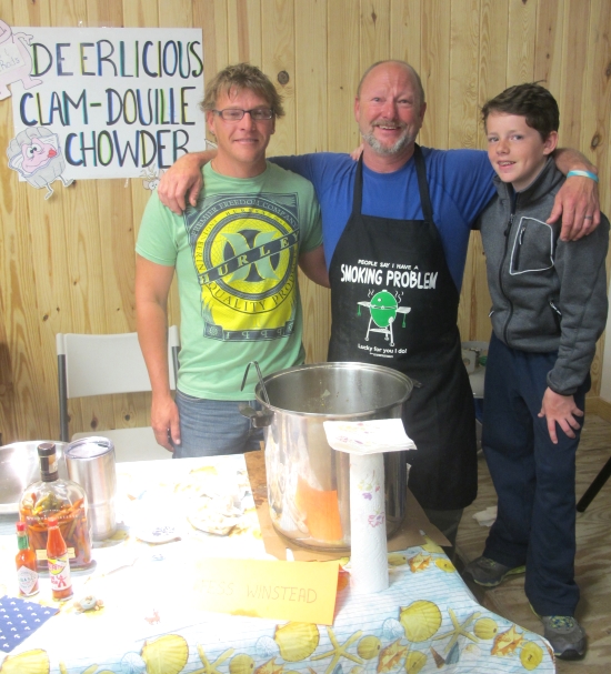 Deerlicious Clam-Douille Chowder: Fess Winstead with friend and chowder apprentice Brad “Bee Rad” Yeatman (left) and Winstead’s sixth-grader son Lee (right), who helped add spices. Ingredients: clams, venison sausage, Andouille sausage, salt meat, sweet potatoes, onions, corn, heavy whipping cream, clam broth, beef broth, pepper. Photo: Leanne E. Smith, 4-4-2015.