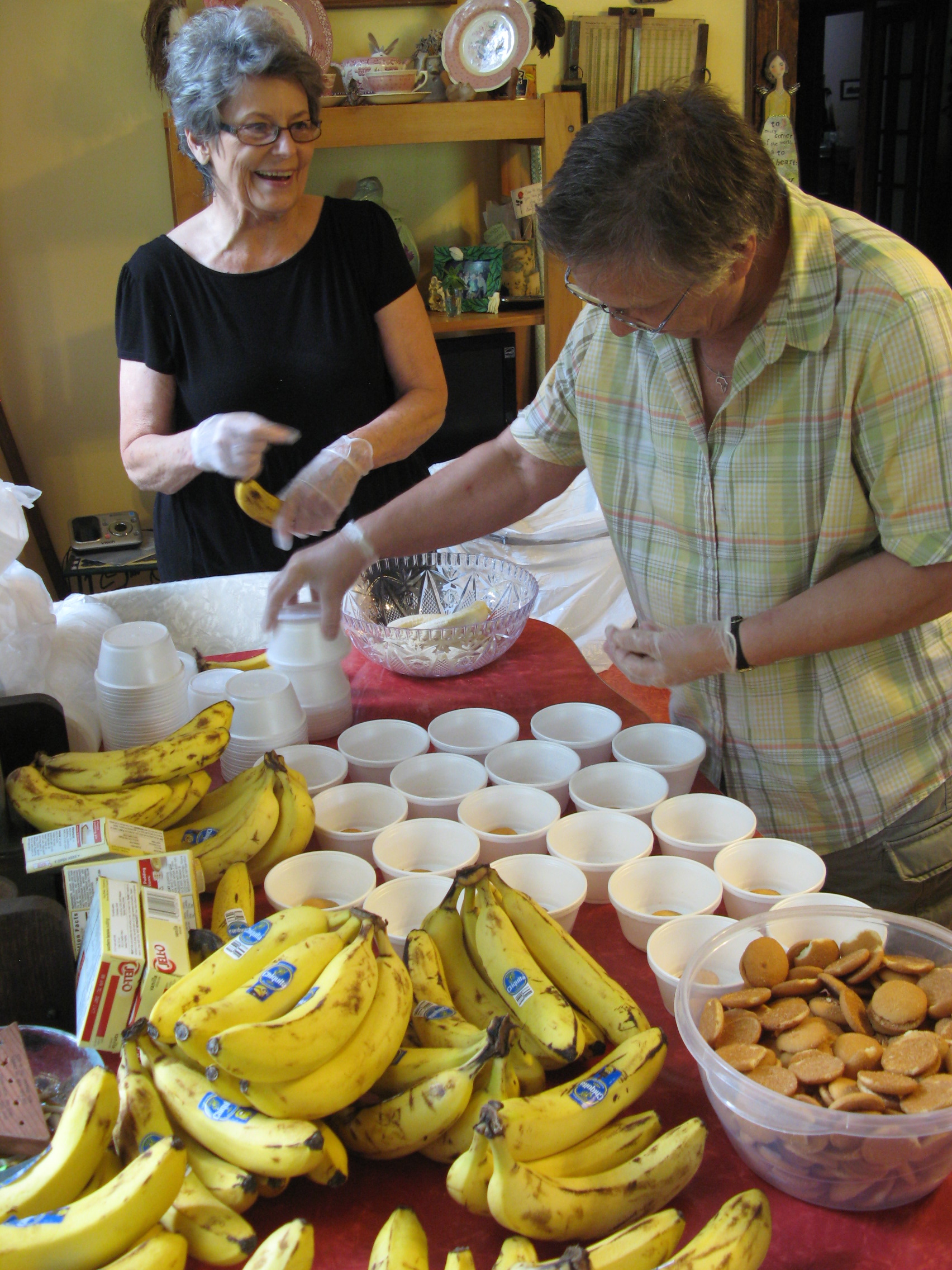 Pat Franklin (left) and Judy Ricker (right) packing cups of banana pudding. Pat used to work in social services for Madison County, and for almost ten years, she managed Elaine’s, a nightclub at the Grove Park Inn. Now she coordinates entertainment at the Depot in downtown Marshall. Judy’s family is from over in Shelton Laurel, and she is a quilter who also writes about people and events in Madison County, the way downtown Marshall used to be, etc. Friday, June 12, 2015. Leanne E. Smith. 