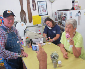 During an ice cream break, Margo writes down a phoned-in order, and Margie talks with customers and poses for pictures. Monday, September 7, 2015. (Leanne E. Smith)