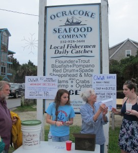 Patty Plyler (center, holding envelope), who manages the fish house, collected admission and thanked customers for their business in the last year.  December 30, 2015. (Leanne E. Smith.)