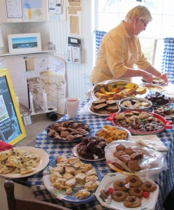 Pat Austin slices a blueberry pie inside the Ocracoke Working Watermen’s Exhibit.  December 30, 2015. (Leanne E. Smith)