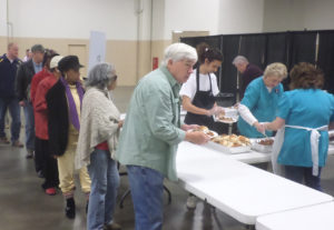 Another plate is served as the waiting line advances. (Ray Linville)