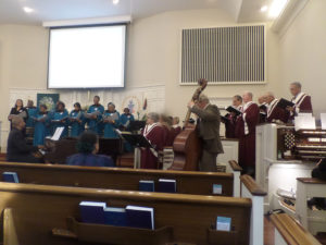 Choirs of Trinity AME Zion and Bethesda Presbyterian combine voices in singing “This Is the Day.” (Ray Linville)