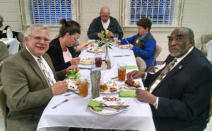 Musicians Larry Arnold of Bethesda Presbyterian (left) and Carlton Bolton of Trinity AME Zion (right) join others in appreciating home-cooked food. (Ray Linville)