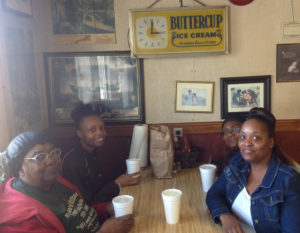 The Munn family sit under a clock that’s been on the wall since 1963. “They eat here every week,” she says. (Ray Linville)