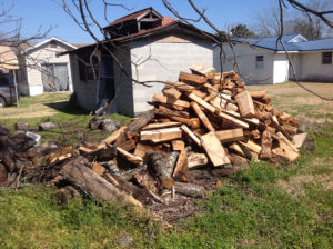 A well-stocked woodpile sits next to the small building in the McRae backyard where the barbecue pit is located. (Ray Linville)