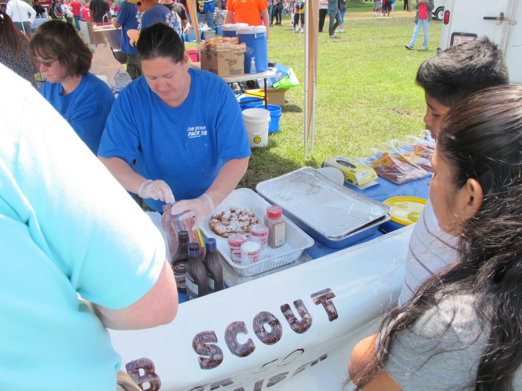 Boy Scouts raising funds for summer camp. Cake baker Mary Beth Houston is in the background at the right. Saturday, May 7, 2016.