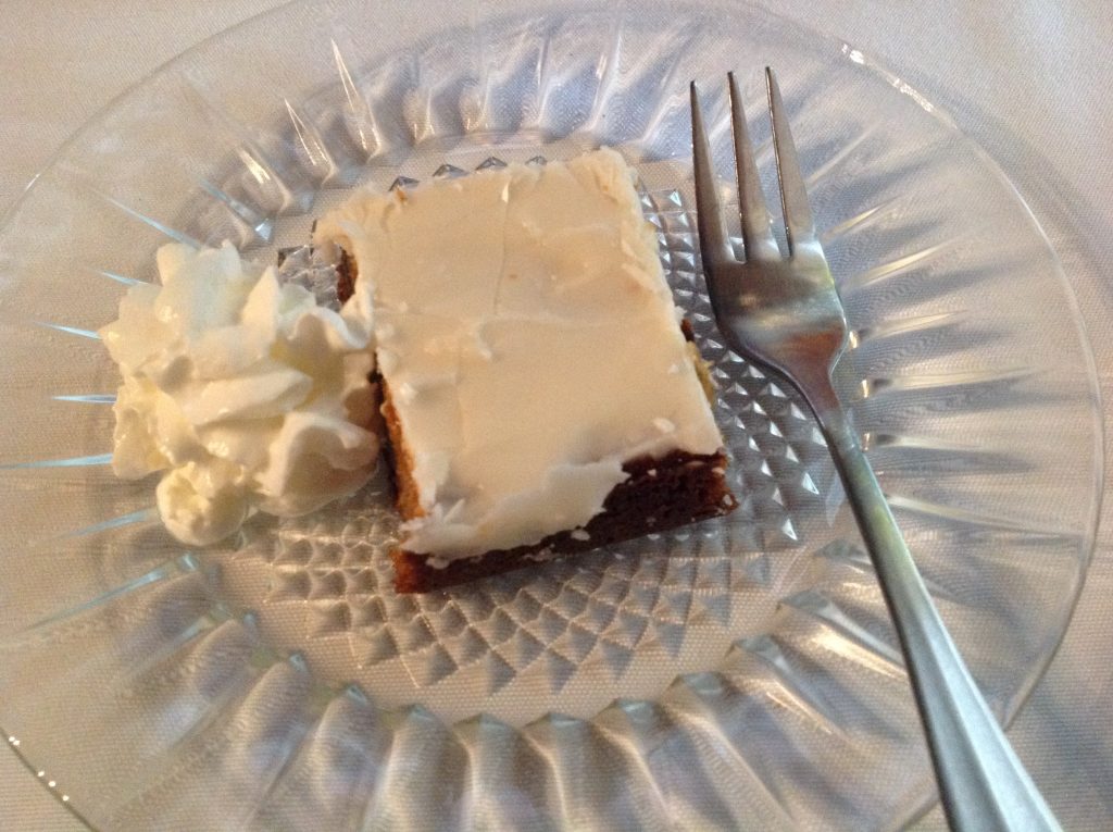Prune cake with whipped cream topping ends a delicious meal.