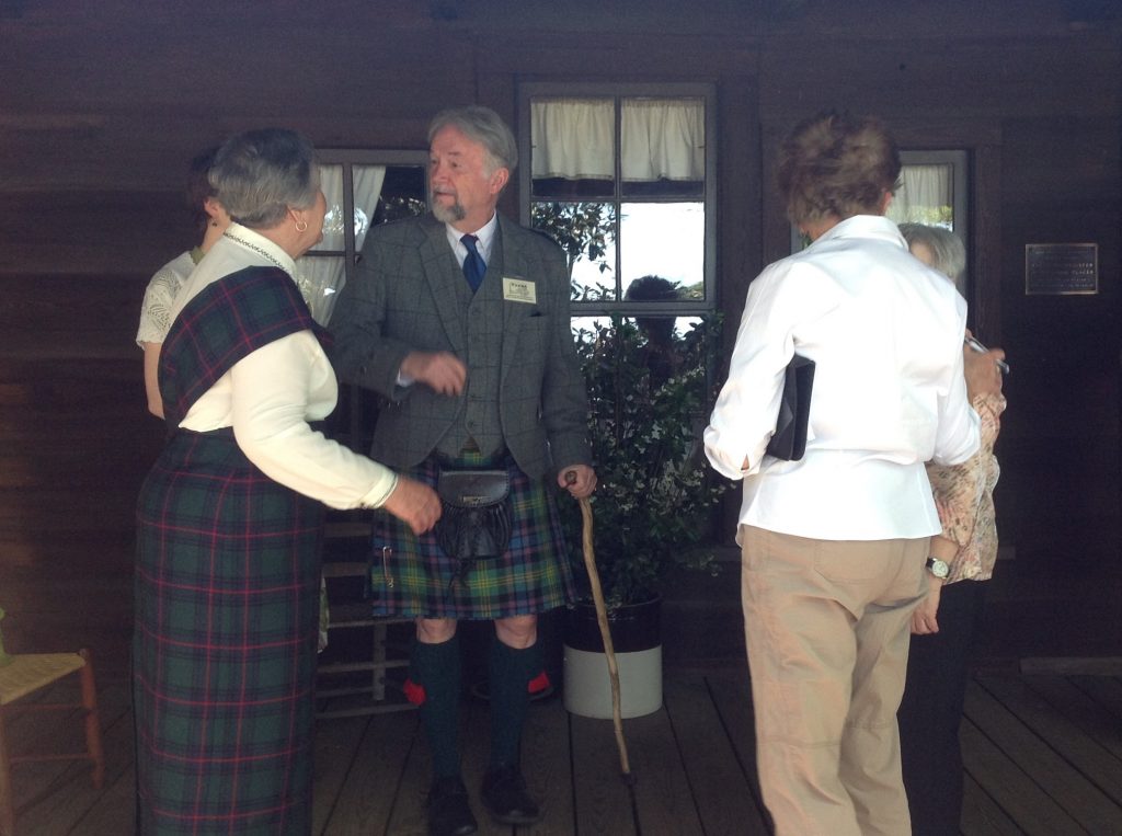 Dorothy Shankle (left) and Frank Pierce (center) greet arrivals on the front porch of the Shaw House.