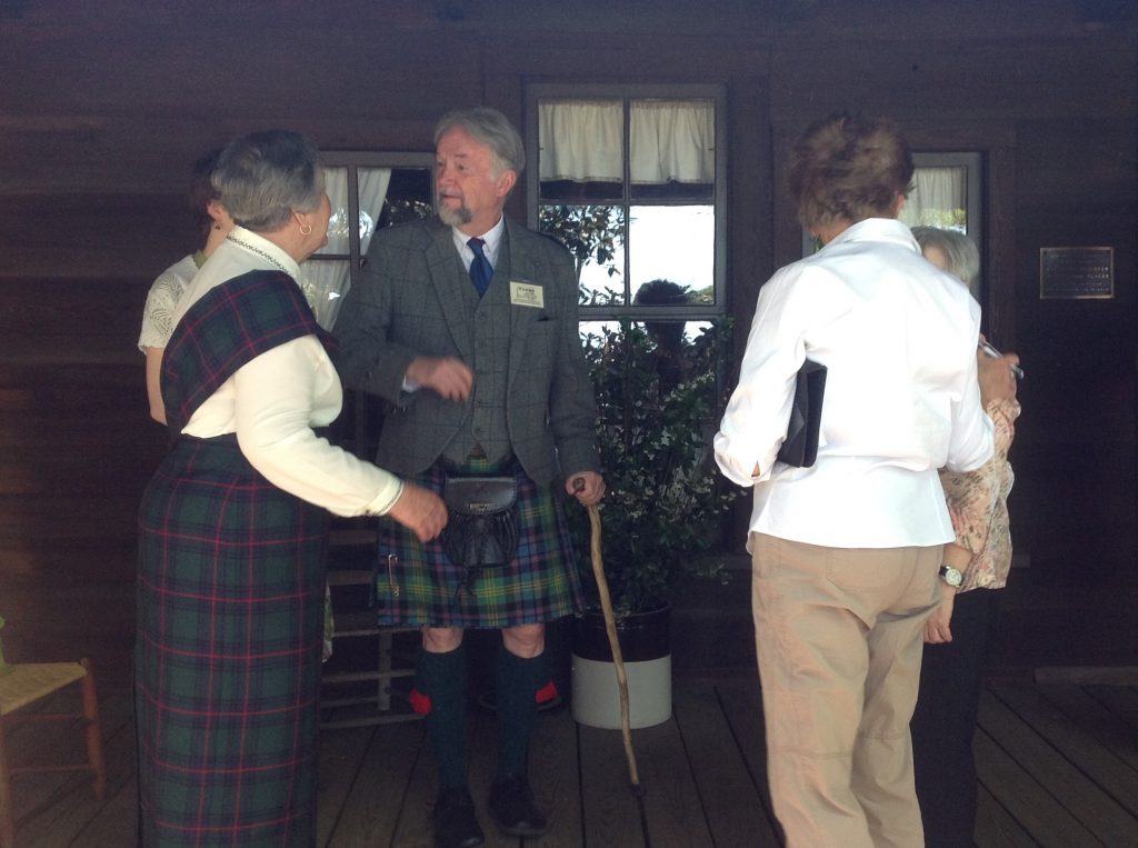 Dorothy Shankle (left) and Frank Pierce (center) greet arrivals on the front porch of the Shaw House. 