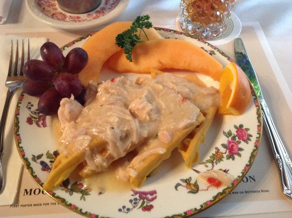 Plates of creamed chicken over waffles, drizzled with maple syrup, and a side of fresh fruit bring back memories from five decades ago.