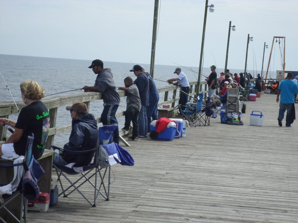 The fishing pier at Carolina Beach is lined with hopeful anglers who want to take home a few spots.