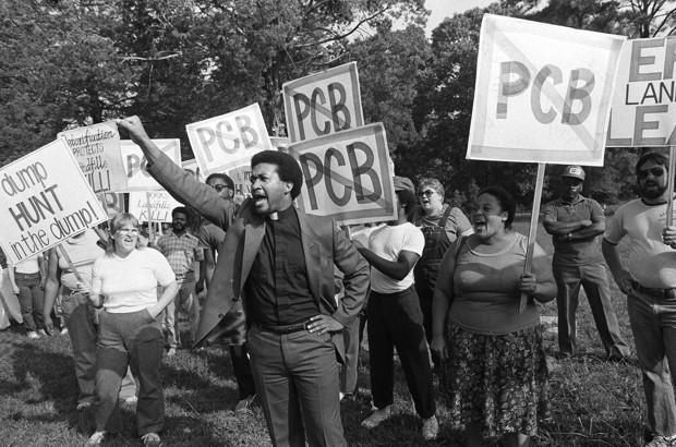 Rev. Ben Chavis, right, raises his fist as fellow protesters are taken to jail at the Warren County PCB landfill near Afton, North Carolina on Thursday, Sept. 16, 1982. Chavis is one of the members of the Wilmington 10. (AP Photo/Greg Gibson)